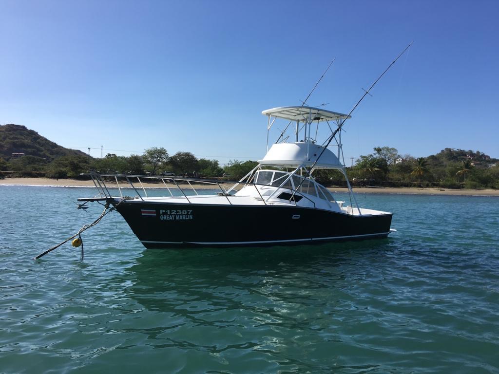 Great Marlin at anchor, black hull and white tuna tower, Herradura Bay